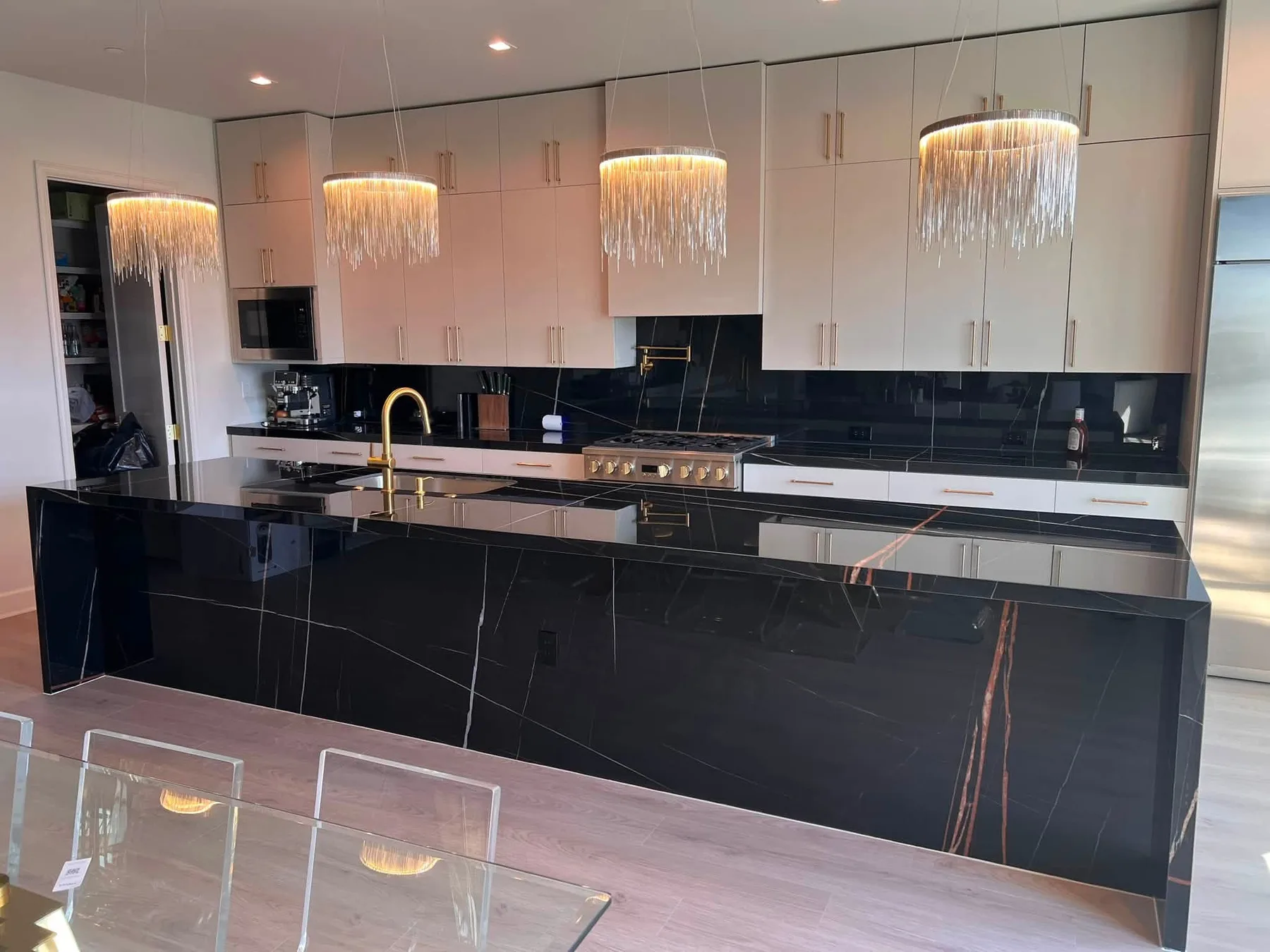 Black porcelain counters with a full-height backsplash — Kitchen