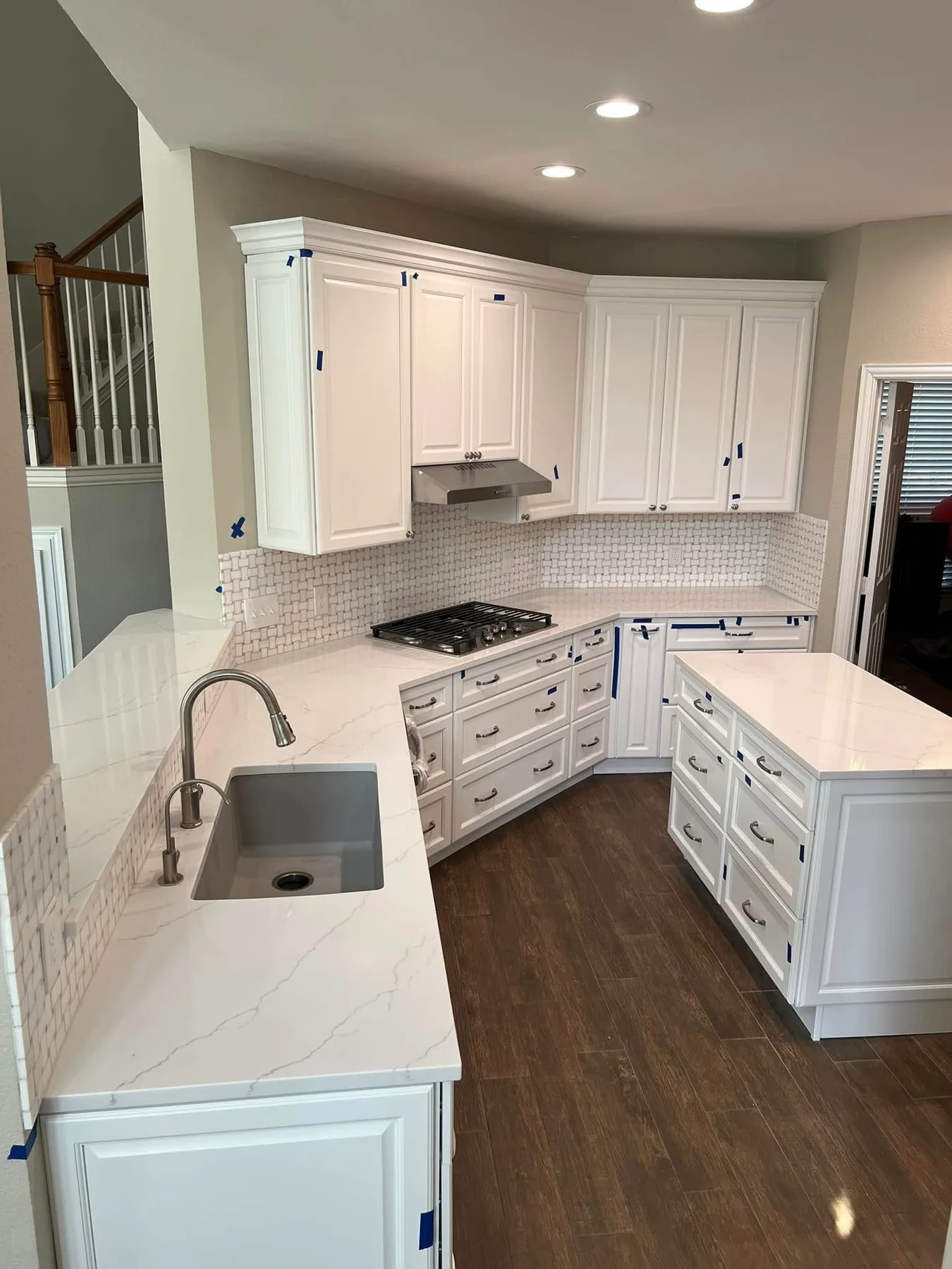 White quartz counters with an undermount sink — Kitchen